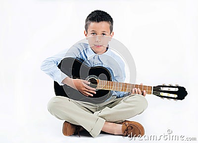 Handsome brunette boy playing guitar on white isolated background Stock Photo