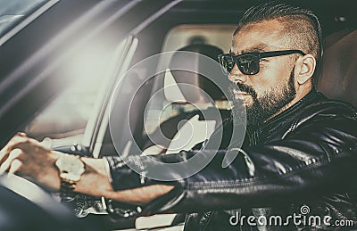 Handsome brutal young man behind the wheel of a luxury car Stock Photo