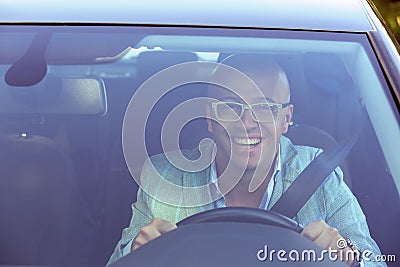 Handsome business man smiling looking out of his new car window Stock Photo