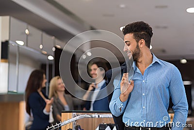 Handsome Business Man And Woman Fashion Shop, Customers Choosing Clothes In Retail Store Stock Photo