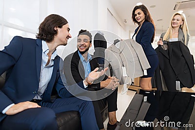 Handsome Business Man And Woman Fashion Shop, Customers Choosing Clothes In Retail Store Stock Photo