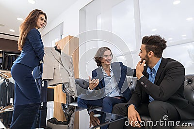 Handsome Business Man And Woman Fashion Shop, Customers Choosing Clothes In Retail Store Stock Photo