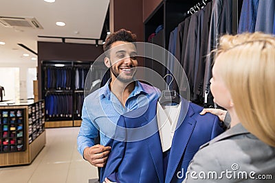 Handsome Business Man And Woman Fashion Shop, Customers Choosing Clothes In Retail Store Stock Photo