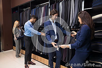 Handsome Business Man And Woman Fashion Shop, Customers Choosing Clothes In Retail Store Stock Photo