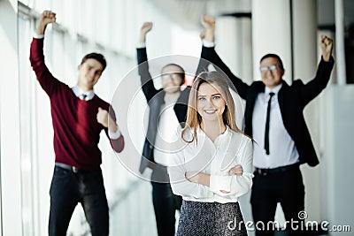 Handsome business womanin front of his team member celebrating their achievement in office Stock Photo