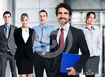 Handsome businessman in front of his team Stock Photo