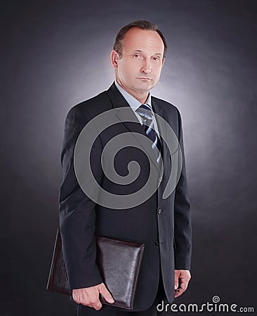 Handsome businessman with a leather folder . on black Stock Photo