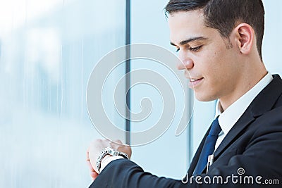 Handsome businessman looking at his watch. Stock Photo