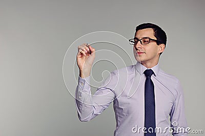 Handsome businessman in shirt,tie, glasses holding pen. Writ Stock Photo