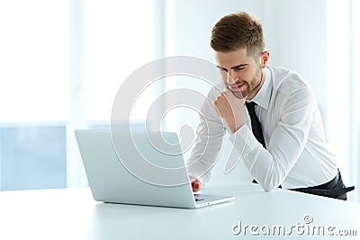 Handsome Businessman Working on Laptop at His Office Stock Photo