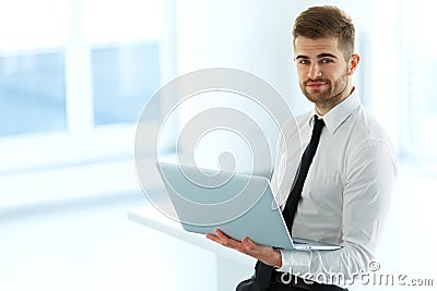 Handsome Businessman Working on Laptop at His Office Stock Photo