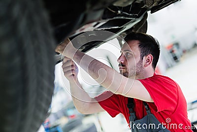 Car mechanic working at automotive service center Stock Photo