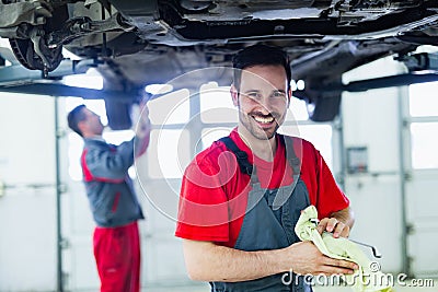 Car mechanic working at automotive service center Stock Photo