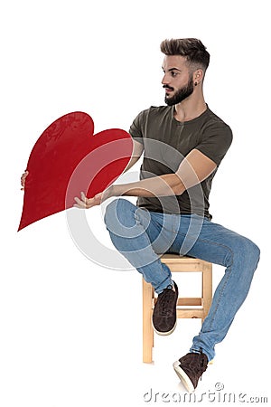 Handsome casual man offering a heart Stock Photo