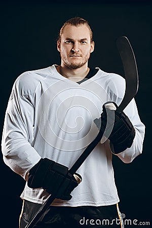 Handsome hockey player. Smiling at camera isolated on white Stock Photo