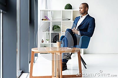 Handsome cheerful african american executive business man at the workspace office. Stock Photo