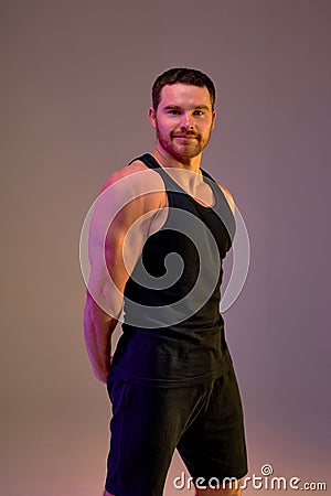 handsome cheerful happy bodybuilder shows strong hands and back muscles Stock Photo