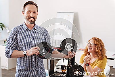 Handsome cheerful man standing with filament coils Stock Photo