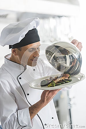 handsome chef sniffing food Stock Photo