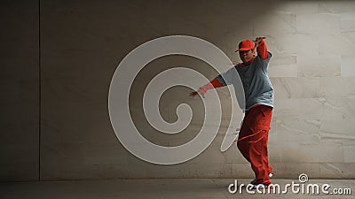 Handsome choreographer practice street dance in gray background. Sprightly. Stock Photo