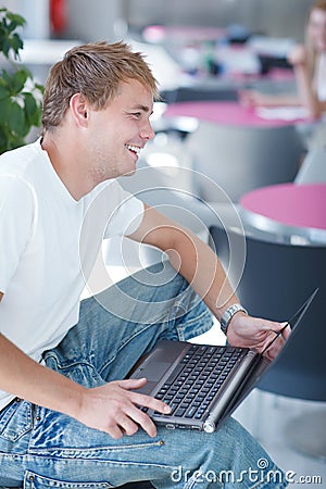 Handsome college student using a computer Stock Photo