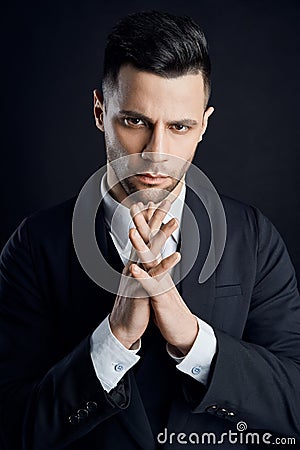 Handsome concentrated business man on black background Stock Photo