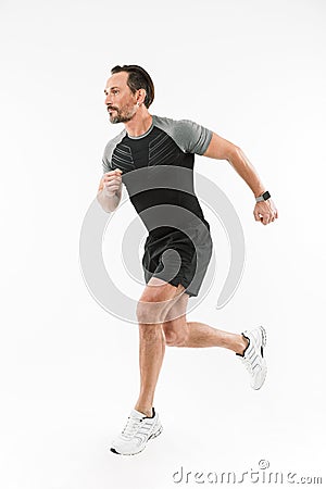 Handsome concentrated mature sportsman running Stock Photo