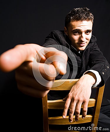 Handsome confident young man with finger pointing Stock Photo