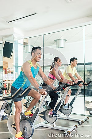 handsome and confident young man during group class of HIIT indo Stock Photo