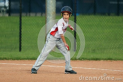 Handsome cute Young boy playing baseball waiting and protecting the base. Stock Photo