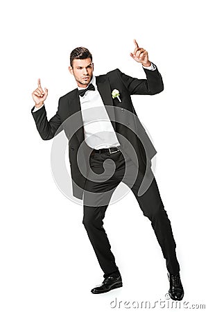 handsome dancing young groom pointing up Stock Photo