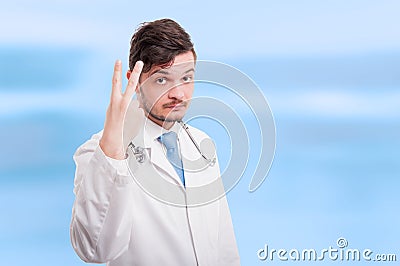 Handsome doctor or medic counting two Stock Photo