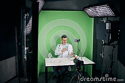 Handsome doctor recording video for medical vlog Stock Photo