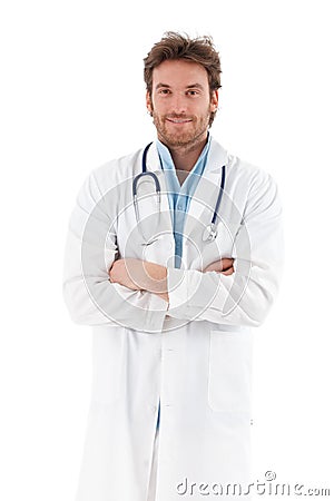 Handsome doctor standing arms crossed smiling Stock Photo