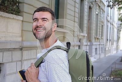 Handsome entrepreneur walking with his elegant backpack Stock Photo