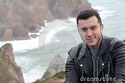 Handsome ethnic man with winter ocean landscape Stock Photo
