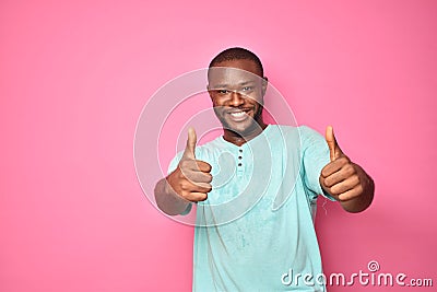 handsome excited young black man feeling excited giving thumbs up gesture Stock Photo