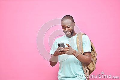 handsome excited young black man feeling excited while viewing content on his smartphone Stock Photo