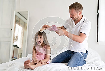 Handsome father takes care of her daughter.Father dries hair wit Stock Photo