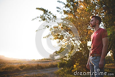 Handsome fit man posing in forest Stock Photo