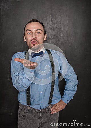 Handsome funny romantic man sending kiss on blackboard Stock Photo