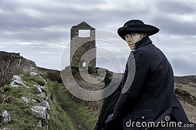 Handsome Male Horse Rider Regency 18th Century Poldark Costume with tin mine ruins and countryside in background Stock Photo