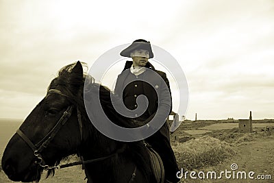 Handsome Male Horse Rider Regency 18th Century Poldark Costume with tin mine ruins and countryside in background Stock Photo