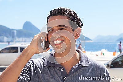 Handsome guy at Rio de Janeiro speaking at phone Stock Photo