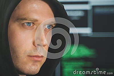 Handsome hacker in black hoodie. Stock Photo