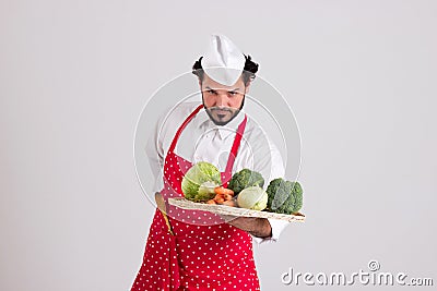 Handsome Head cook is Holding a Wicker Tray with Vegetables Stock Photo