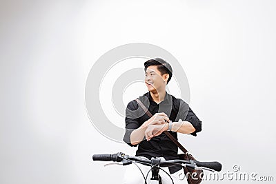 Handsome hipster enjoying a bike ride and checking time on his watch Stock Photo