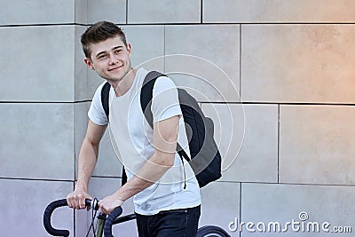 Handsome hipster man posing with bicycle in the city. Stock Photo