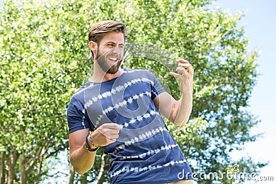 Handsome hipster playing air guitar Stock Photo