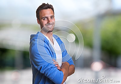 Handsome hispanic man with hoodie looking at camera Stock Photo